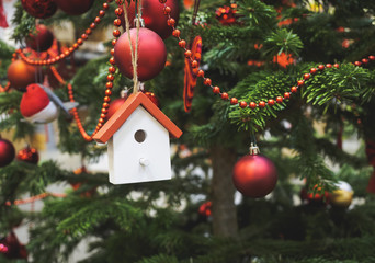 Christmas tree decoration wooden house ornament close up