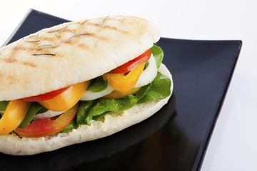 Vegetable sandwich on black plate