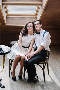 Portrait of young couple in classic clothes posing modest.