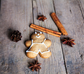 Christmas homemade gingerbread man on wooden background. Large c