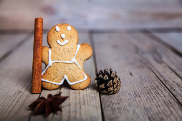 Christmas homemade gingerbread man on wooden background. Large c