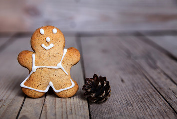 Christmas homemade gingerbread man on wooden background. Large c