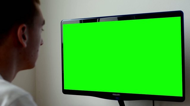 man works on computer - green screen - office - closeup