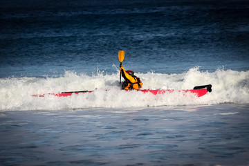 Kayak surfing on rough sea