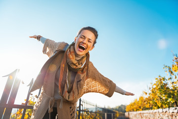 Happy young woman having fun time in autumn outdoors