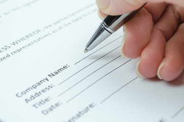 Female hand filling document