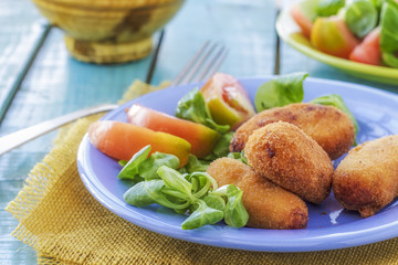 broiled dish with salad