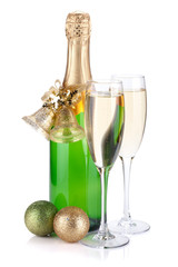 Champagne bottle, glasses and christmas decor