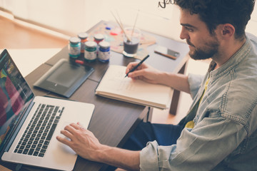 handsome hipster modern man working home using laptop - obrazy, fototapety, plakaty