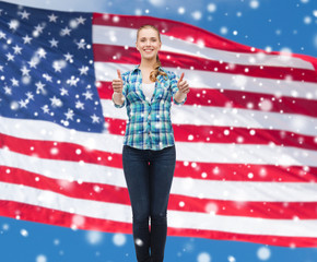 smiling girl in casual clothes showing thumbs up