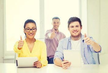 smiling team with tablet pc computers at office