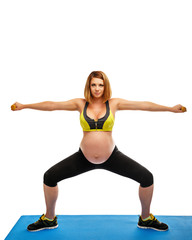 Pregnant woman doing gymnastic exercises