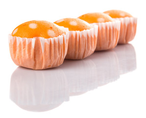 Orange colored steamed rice polka dot muffin or apam polka dot 