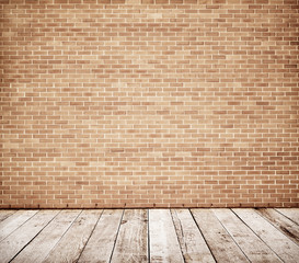 Tall brick wall with wooden floor