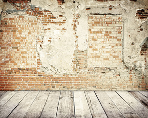 Tall brick wall with wooden floor
