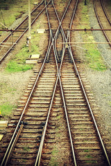 Vintage retro filtered picture of railway tracks junction.