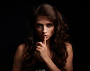 Beautiful make-up woman showing silence sign the finger