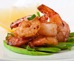 Shrimp sauteed with garlic and soy sauce on a cushion of avocado