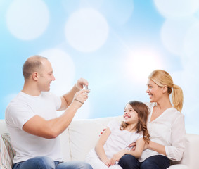 happy family with camera at home