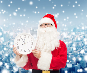 man in costume of santa claus with clock