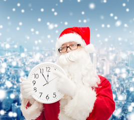 man in costume of santa claus with clock