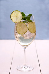 Hugo cocktail with lime, mint and ice cubes