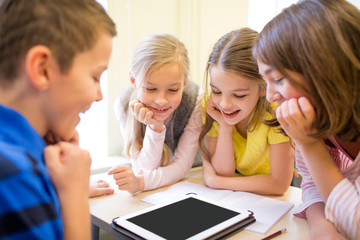 group of school kids with tablet pc in classroom