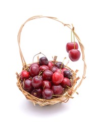 Cherry in basket isolated on white background