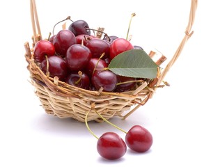 Cherry in basket isolated on white background