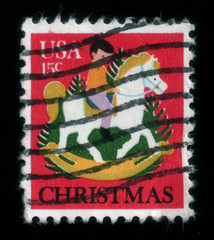 Child on rocking horse. Christmas Postage Stamp