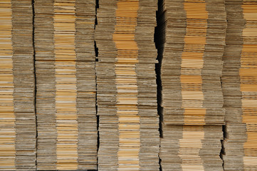 Many unpack paper box stacking on black pallet in front of wareh