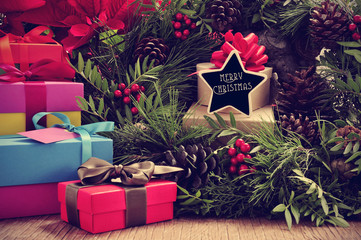 gifts, christmas wreath and text merry christmas in a star-shape