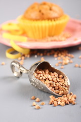 Metal shovel with buckwheat grain and muffin
