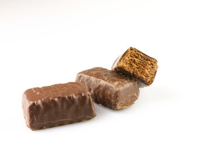 Bitten chocolate candy on a white background.