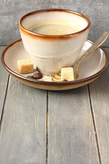 Cup of coffee, sugar cubes and chocolate drops