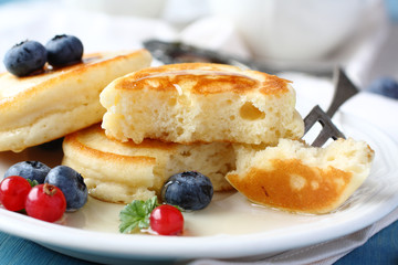 Homemade delicious pancakes with fresh berries and honey