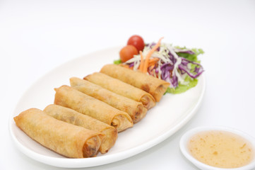 Fried spring rolls on white plate.