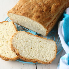 Homemade gluten free bread on blue metal grid