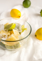 Lemons and limes on the white background