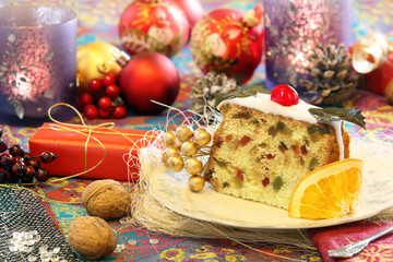 Christmas holly fruitcake on the decorated table