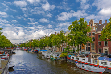 Fototapeta na wymiar City view of Amsterdam canalsand typical houseboats, Holland, Ne