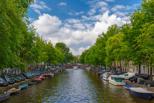 City view of Amsterdam canal with boats, Holland, Netherlands.