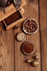 grated coffee in old iron weights and wooden  background