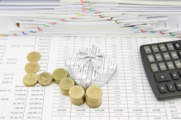 Pile of gold coin beside gift box