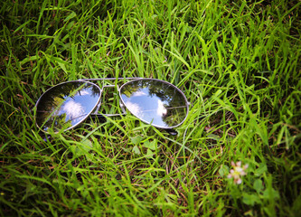 reflective sunglasses on grass
