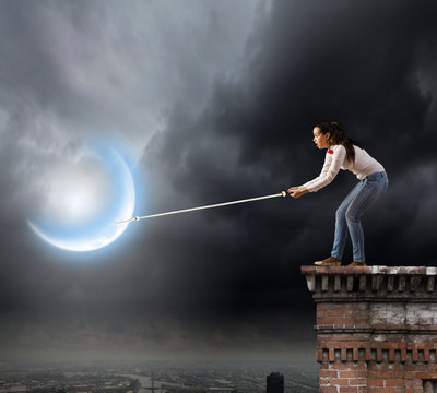 Woman catching moon