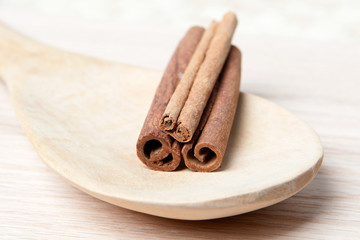 Cinnamon sticks on a wooden spoon