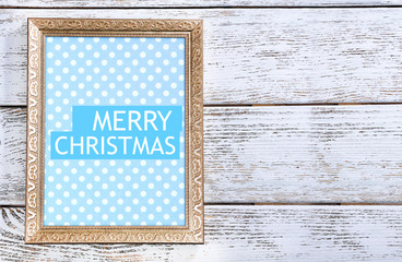 Fototapeta premium Christmas greeting card with frame on wooden background
