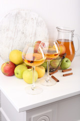 still life with apple cider and fresh apples on wooden table