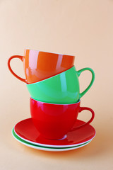 Colorful cups on color background